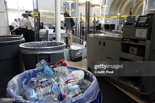 Trash can filled with containers sits near a security checkpoint in Los Angeles International Airport August 11, 2006 Los Angeles, California....