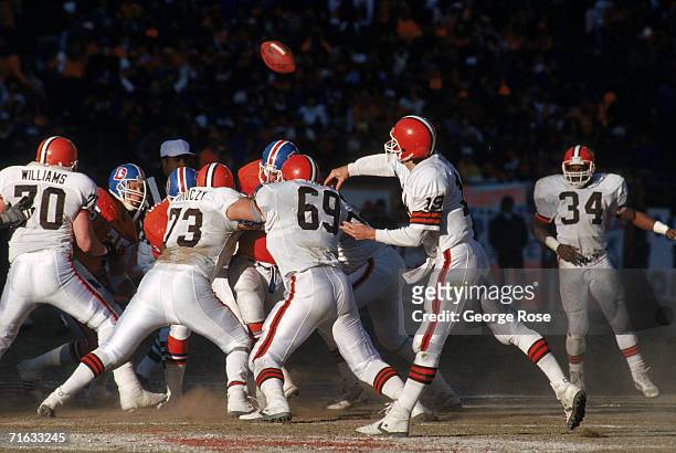 Quarterback Bernie Kosar of the Cleveland Browns releases the ball behind strong protection during the 1987 AFC Championship game against the Denver...
