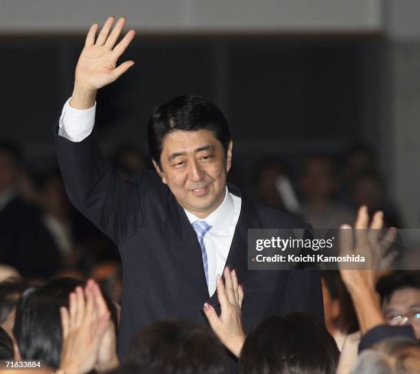 Japanese Chief Cabinet Secretary Shinzo Abe waves to voters as he attends a press conference to announce his intention to stand as Prime Minister on...