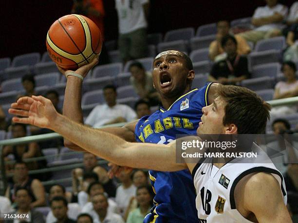 Leandro Mateus Barbosa from Brazil takes a shot as Joe Herber of Germany tries to block during their Stankovic Continental Champions Cup game in...