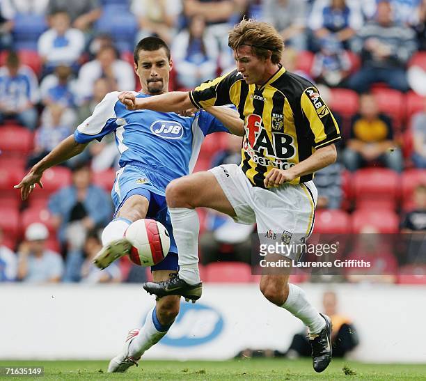 Mads Junker of Vittesse battles for the ball with Paul Scharner of Wigan during the Pre Season Friendly between Wigan Athletic and Vitesse Arnhem at...