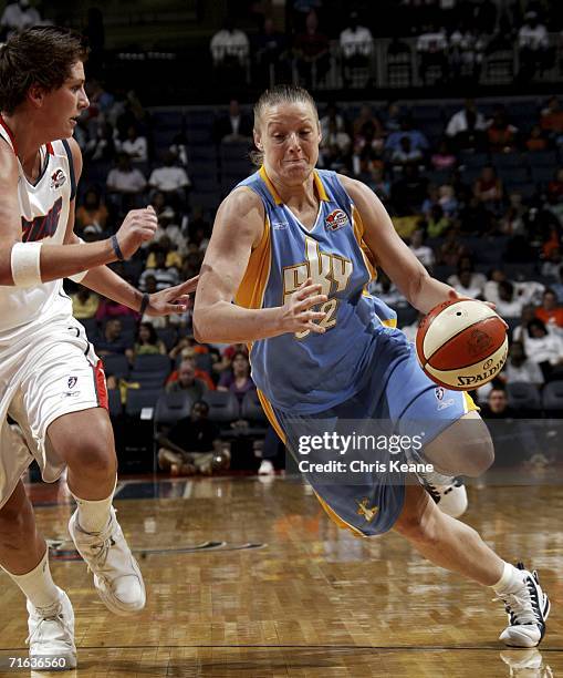 Stacey Lovelace-Tolbert of the Chicago Sky drives the ball around Janel McCarville of the Charlotte Sting on August 12, 2006 at the Charlotte Bobcats...
