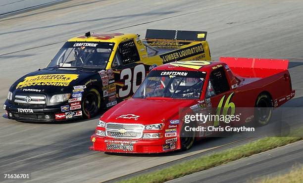 Todd Bodine, driver of the Lumber Liquidators Toyota fights for position with Mike Bliss, driver of the Xpress Motorsports Chevrolet during the...