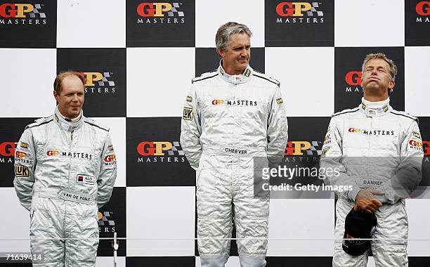 Eddie Cheever celebrates on the podium after winning the GP Masters of Great Britain with Eric van de Poele and Christian Danners at Silverstone...