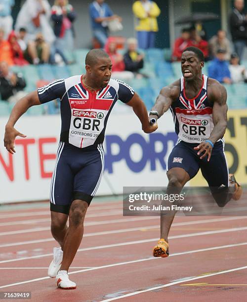 Dwain Chambers of Great Britain passes the baton to team mates Darren Campbell during the Men's 4 x 100 Metres Relay Final on day seven of the 19th...