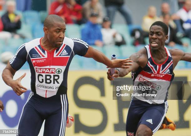 Dwain Chambers of Great Britain passes the baton to team mates Darren Campbell during the Men's 4 x 100 Metres Relay Final on day seven of the 19th...