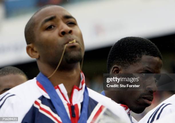 Team Great Britain members Darren Campbell and Dwain Chambers stand with their gold medals during the medal presentation for the Men's 4 x 100 Metres...