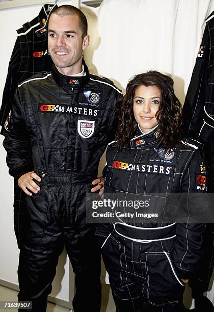 Mark Hynes poses with Katie Melua as she gets ready to be driven around the track by him in the two seater GP masters car during the GP Masters of...