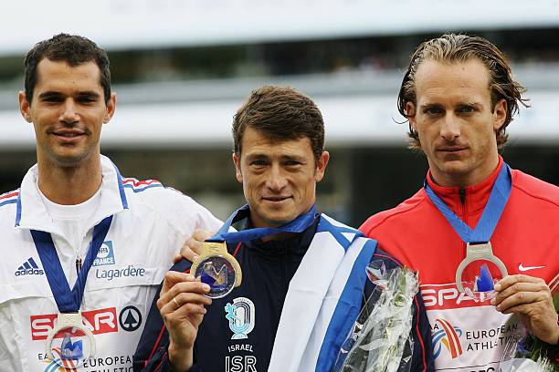 Gold medallist Alex Averbukh of Israel poses with joint silver medallists Tim Lobinger of Germany and Romain Mesnil of France during the medal...