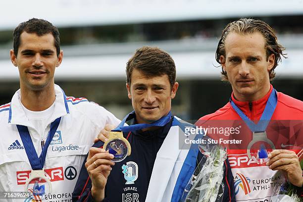 Gold medallist Alex Averbukh of Israel poses with joint silver medallists Tim Lobinger of Germany and Romain Mesnil of France during the medal...