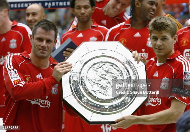 Jamie Carragher and Steven Gerrard of Liverpool hold the trophy following their team's victory during the FA Community Shield match between Liverpool...