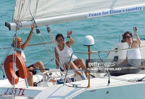 Portuguese skippers Maria Fatima, Catarina Montero and Mafalda Ribeira wave to photographers as they leave the port of Sidi Bou Said in Tunis, 13...
