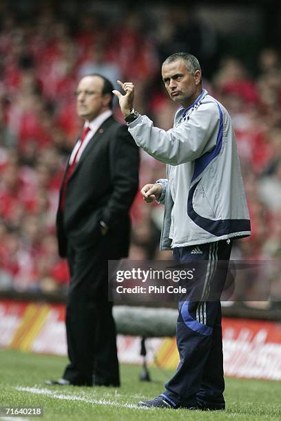 Jose Mourinho , the Chelsea Manager gestures to his players, as Rafael Benitez, the Liverpool Manager looks on during the FA Community Shield match...