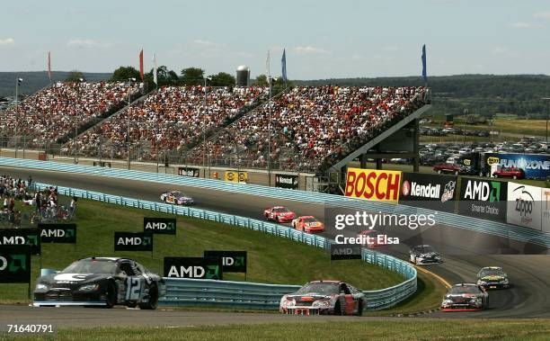 Ryan Newman, driver of the Alltel Dodge, leads Kevin Harvick, driver of the GM Goodwrench Chevrolet, and others during the NASCAR Nextel Cup Series...