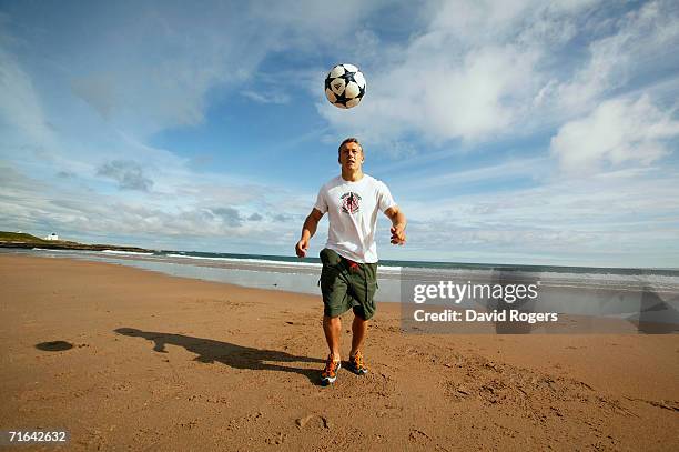 England and Newcastle Fly Half Jonny Wilkinson relaxes with a football on Bamburgh Beach during a feature on May 14, 2004 in Northumberland, England.