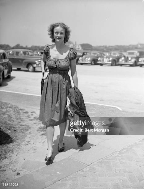 American social activist and diplomat Marietta Tree carries a coat over her arms as she walks to the entrance of the Southampton Bathing Corporation,...