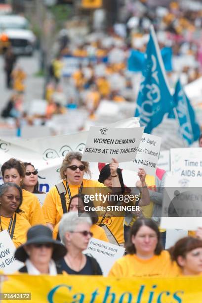 Demonstrators march through the streets of Toronto, Canada Monday 14 August, 2006 demanding equality for women in the international fight against...