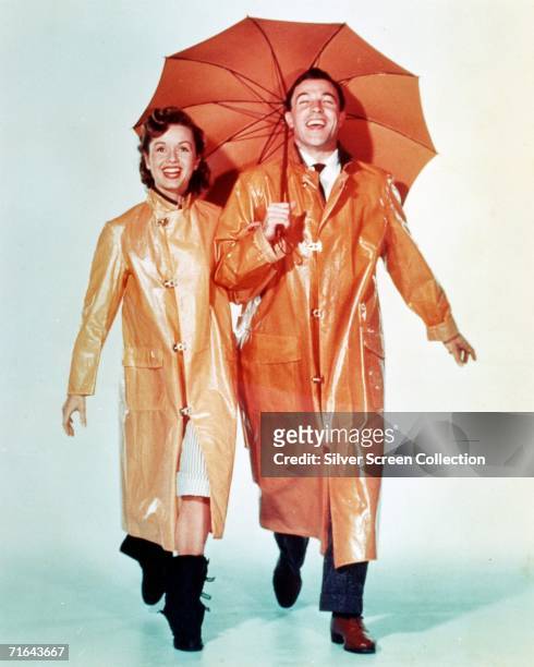 American dancer and actor Gene Kelly as Don Lockwood and Debbie Reynolds as Kathy Seldon in 'Singin' in the Rain', directed by Stanley Donen and...
