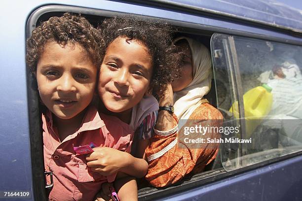 Lebanese refugee children travel between Syria and Lebanon on August 14, 2006 at the Lebanese checkpoint of al-Masnaa. Hundreds of Lebanese crossed...