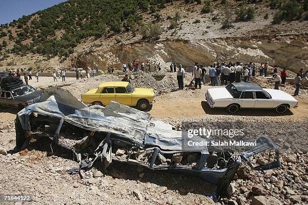 Lebanese refugees navigate craters and destroyed vehicles in the road as they travel between Syria and Lebanon on August 14, 2006 at the Lebanese...