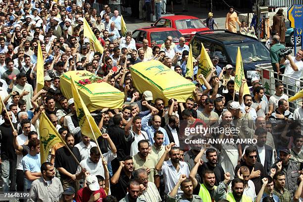 Relatives and comrades of two Hezbollah fighters carry their coffins during their funeral procession in the southern Lebanese town of Nabatiyeh, 15...