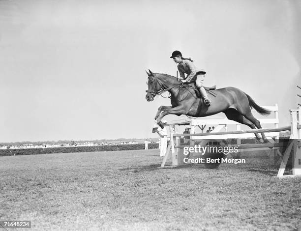 American future first lady Jacqueline Bouvier jumps a fence on her horse Danseuse during the East Hampton Horse Show at the Riding Club of East...