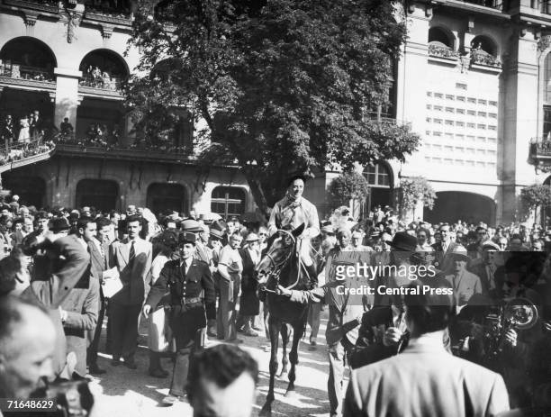Mounted jockey during the Prix de l'Arc de Triomphe at the Longchamp Racecourse in Paris, circa 1950.