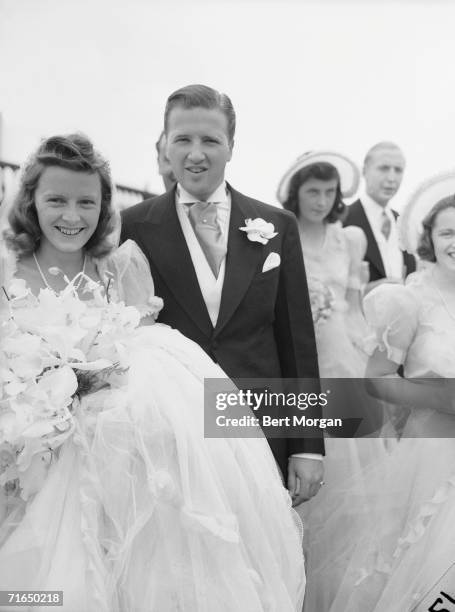 American socialite Anne McDonnell Ford and her new husband automobile executive Henry Ford II pose for a portrait at their wedding, Southampton, New...