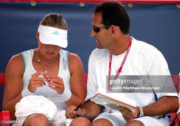 Anna-Lena Groenefeld of Germany confers with her coach, Rafael Font de Mora, between games against Julia Schruff of Germany during the Coupe Rogers...