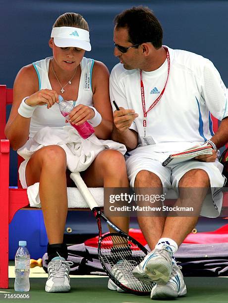 Anna-Lena Groenefeld of Germany confers with her coach, Rafael Font de Mora, between games against Julia Schruff of Germany during the Coupe Rogers...