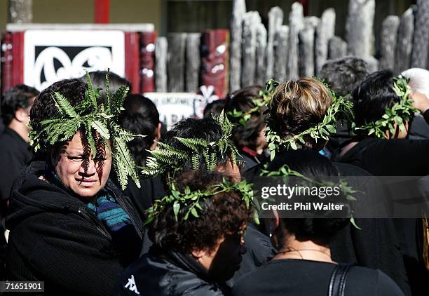 Mourners waiting to pay their respects to the late Maori Queen Dame Te Atairangikaahu, wear traditional Parekawakawa leaves on their heads as a sign...