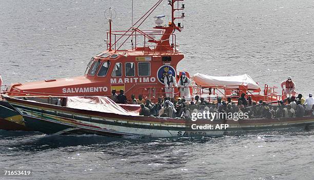 Los Cristianos, SPAIN: A rescue boat of the Spanish Coast guard unit intercepts a 102 would be illegal immigrants "cayucos" boat, off Los Cristianos...