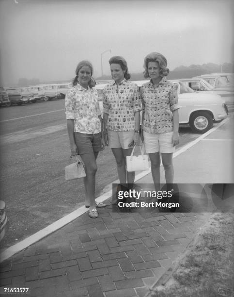 American socialites Robin Lepard, Charlotte Ford, and Anne Ford pause for a picture at the entrance to the Southampton Bathing Corporation,...