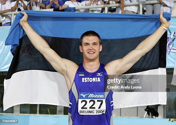 Margus Hunt of Estonia holds up his national flag after winning the Mens Discus on the second day of the 11th IAAF World Junior Championships on...