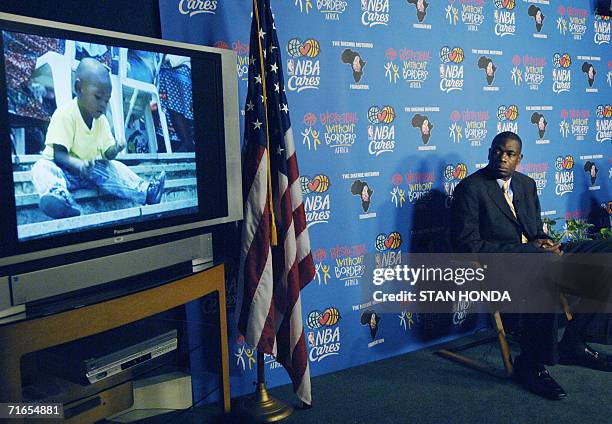 New York, UNITED STATES: Houston Rockets basketball star Dikembe Mutombo watches a video about a 300-bed hospital he helped build in his hometown of...