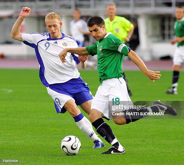 Finland's Mikael Forssell battles with Aaron Hughes of Northern Ireland during the friendly football match Finland vs Northern Ireland in Helsinki,...