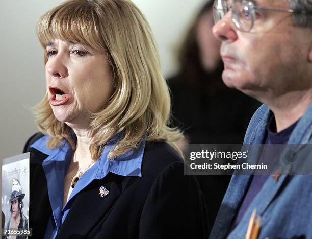 Sally Regenhard speaks as her husband listens during a news conference on newly released emergency calls of the voices of 19 firefighters and two...