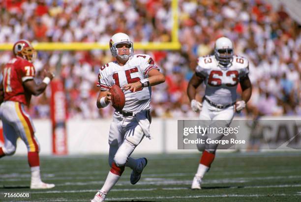 Quarterback Neil Lomax of the Phoenix Cardinals runs as he looks for a receiver down field during a game against the Washington Redskins at Sun Devil...