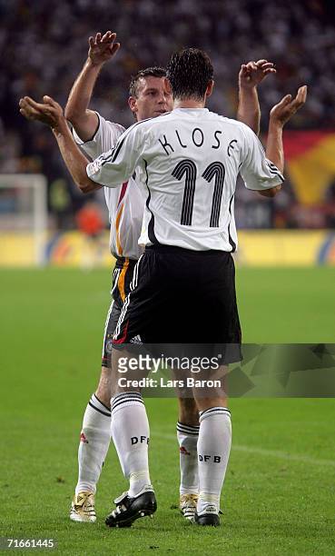Miroslav Klose of Germany celebrates scoring the third goal with team mate Bernd Schneider during the friendly match between Germany and Sweden at...