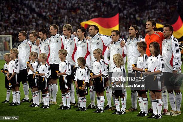 The german players are seen during the national anthem prior to the friendly match between Germany and Sweden at the Arena Auf Schalke on August 16,...