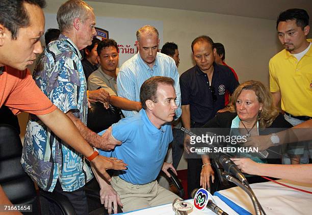 Officials take away US teacher John Mark Karr in the middle of a press conference at the Thai Immigration Department in Bangkok, 17 August 2006. Karr...