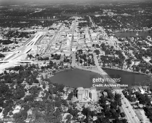 An aerial view of Orlando, Florida, with Lake Lucerne in the foreground, Lake Eola on the middle right, and the new Interstate 4 highway on the left,...