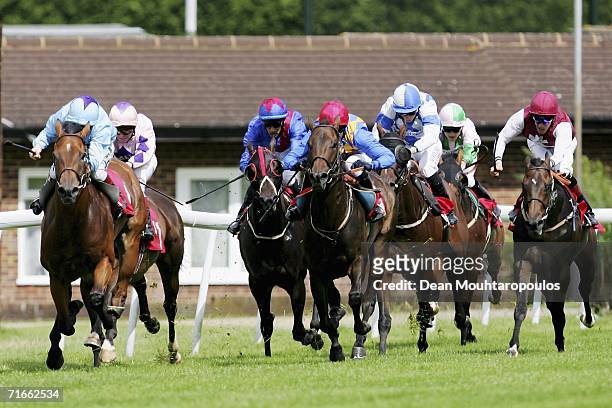 Tamino riden by Martin Dwyer leads the field home to land The Flyers Handicap Stakes Race run at Sandown Park Racecourse on August 17, 2006 in...