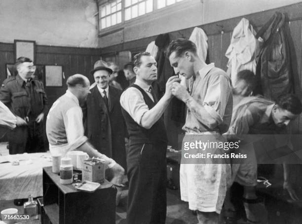 An Arsenal player receiving smelling salts from the trainer in the changing room at White Hart Lane, April 1946. Arsenal defender George Male is...