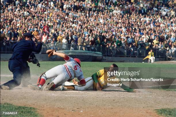 Blue Moon Odom of the Oakland A's is tagged out at the plate by Johnny Bench of the Cincinnati Reds after entering the game as a pinch runner during...