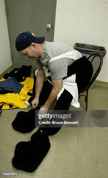 Mike Recktenwald changes into the Pittsburgh Penguins mascot "Iceburgh" before the Pittsburgh Penguins game against the New York Islanders on April...