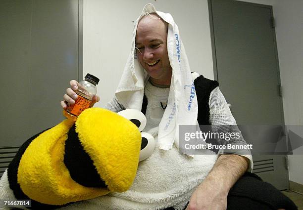 Mike Recktenwald removes the Pittsburgh Penguins mascot "Iceburgh" costume after the Pittsburgh Penguins game against the New York Islanders on April...