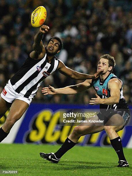 Harry O'Brien of the Magpies marks in front off Josh Mahoney of Port during the round 20 AFL match between the Port Adelaide Power and Collingwood...