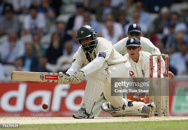 Mohammad Yousuf of Pakistan plays a sweep shot watched by Chris Read of England during day two of the fourth npower test match between England and...