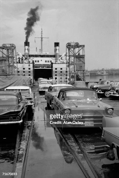 On a rainy day, a ferry gets up steam at La Regla docks in Havana Harbor for the last trip home to Key West - five months before the Bay of Pigs...